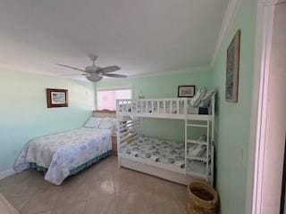 bedroom with ceiling fan, crown molding, and light tile patterned floors