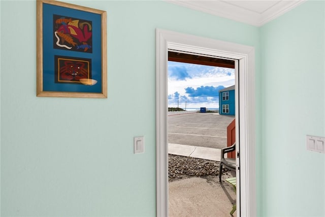 interior space with ornamental molding and carpet flooring