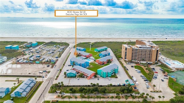 drone / aerial view featuring a view of the beach and a water view