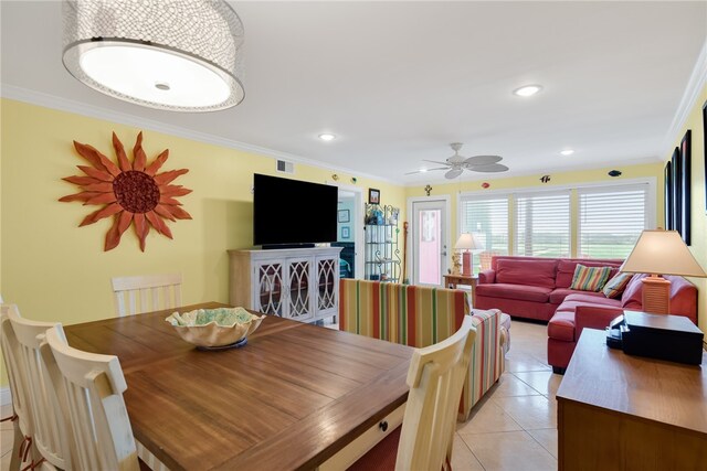 dining space with light tile patterned floors, ornamental molding, and recessed lighting