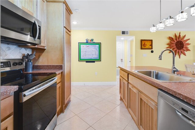 kitchen with a sink, visible vents, appliances with stainless steel finishes, dark countertops, and crown molding