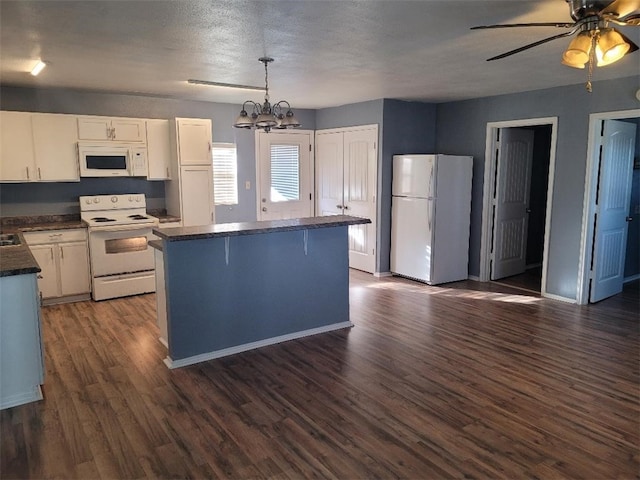 kitchen with white cabinetry, a textured ceiling, pendant lighting, dark wood-type flooring, and white appliances