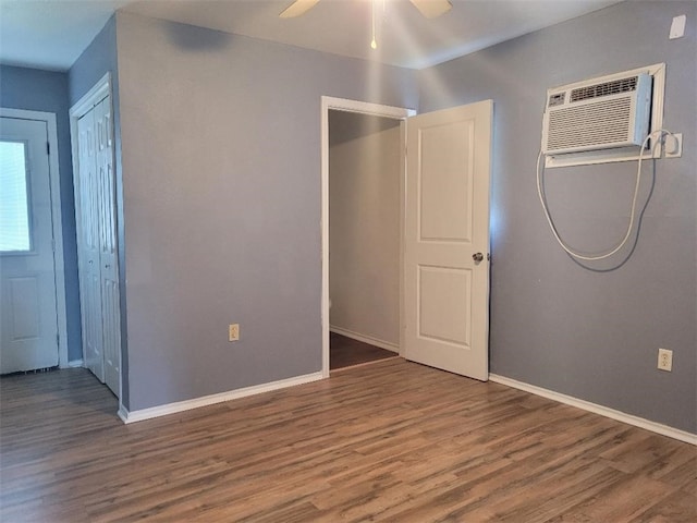 interior space with hardwood / wood-style flooring, ceiling fan, and a wall mounted air conditioner