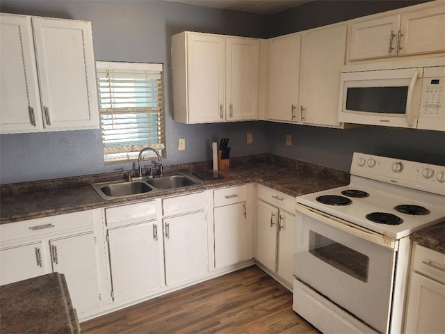 kitchen with white cabinetry, sink, and white appliances