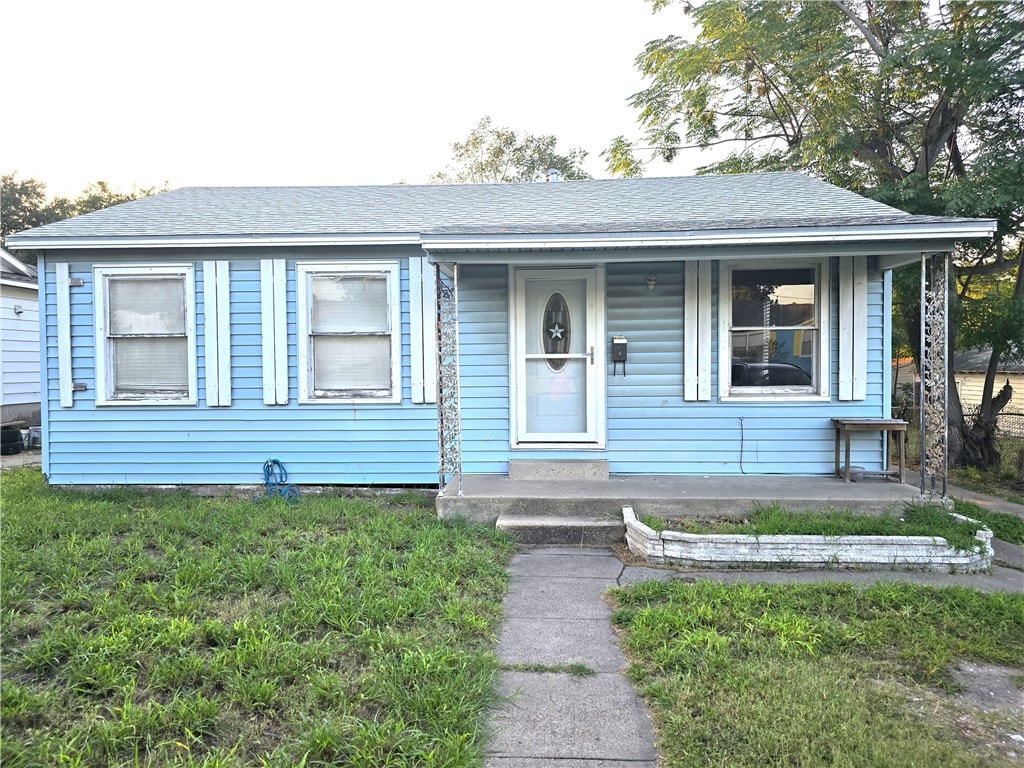 bungalow-style house with a porch and a front lawn