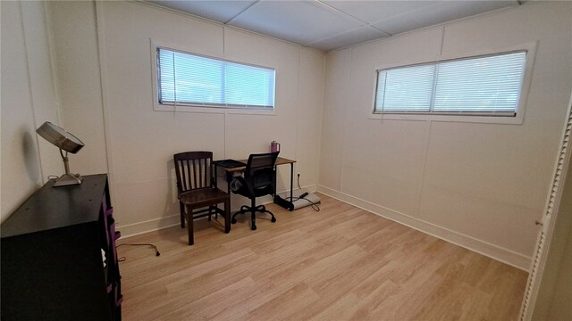office area with light wood-style floors and baseboards