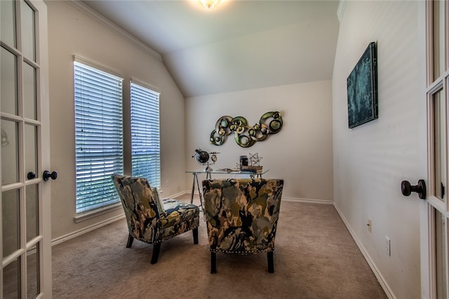 sitting room with vaulted ceiling, light carpet, crown molding, and french doors