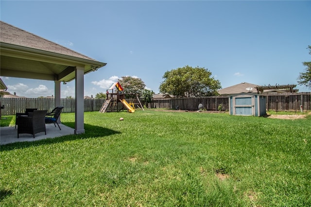 view of yard featuring a playground and a patio area