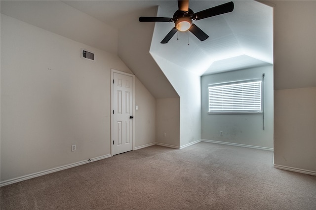 additional living space featuring light carpet, ceiling fan, and vaulted ceiling