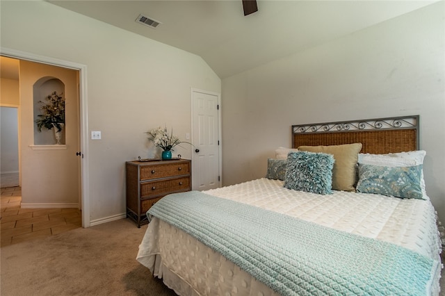 carpeted bedroom with vaulted ceiling and ceiling fan