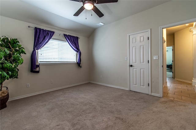 carpeted empty room with lofted ceiling and ceiling fan