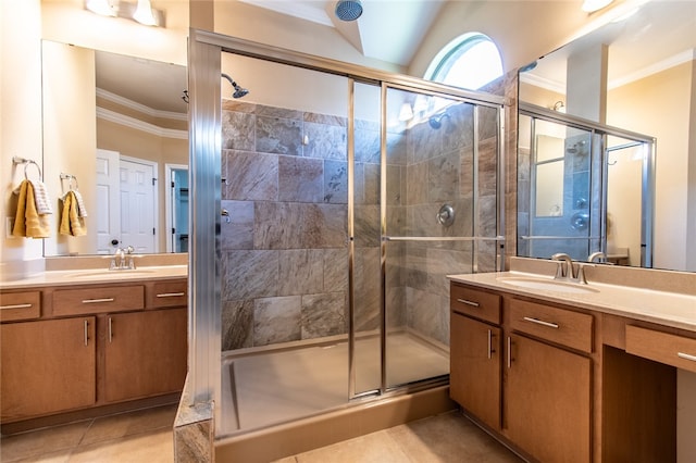 bathroom with vanity, a shower with door, tile patterned flooring, and ornamental molding