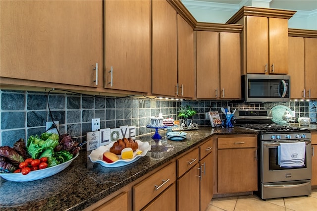 kitchen with stainless steel appliances, light tile patterned floors, backsplash, and crown molding