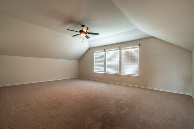 bonus room with vaulted ceiling, carpet flooring, and ceiling fan