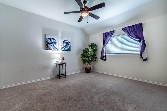 carpeted empty room featuring lofted ceiling and ceiling fan