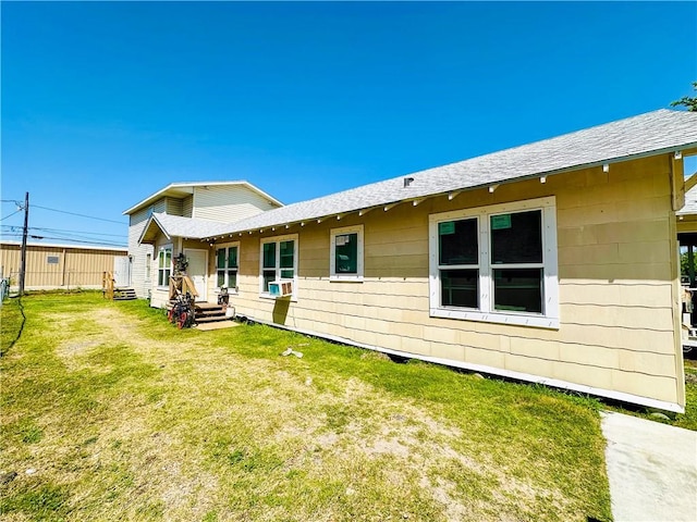 rear view of house with a yard