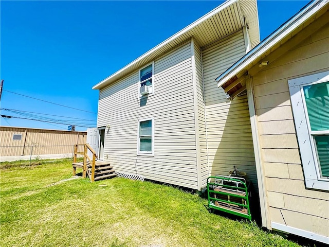 back of house with a lawn and cooling unit