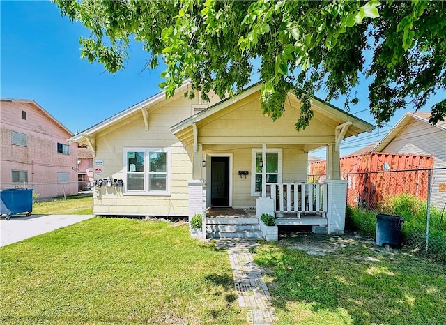 bungalow-style house with covered porch and a front yard