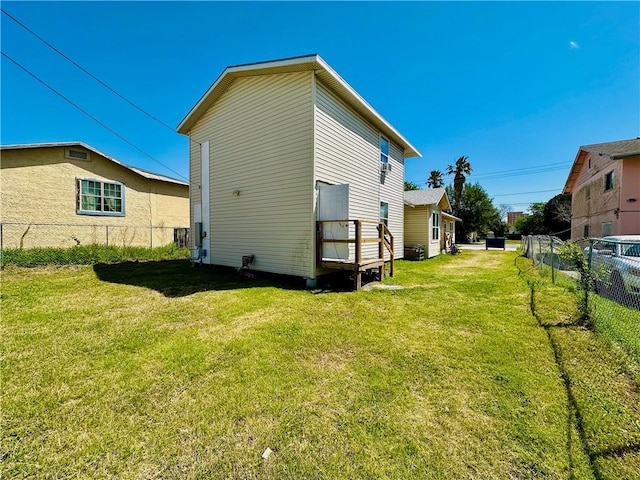 rear view of house featuring a lawn