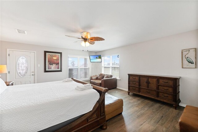 616 Sandcastle Dr, Port Aransas, TX 78373 - bedroom with wood finished floors, baseboards, and a ceiling fan