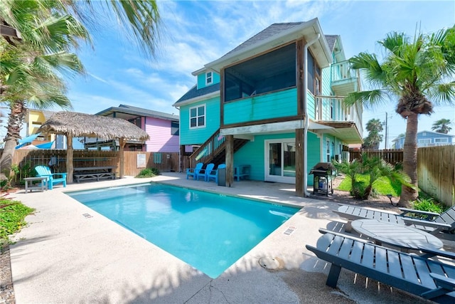 616 Sandcastle Dr, Port Aransas, TX 78373 - rear view of house featuring a fenced backyard, a patio area, and stairs