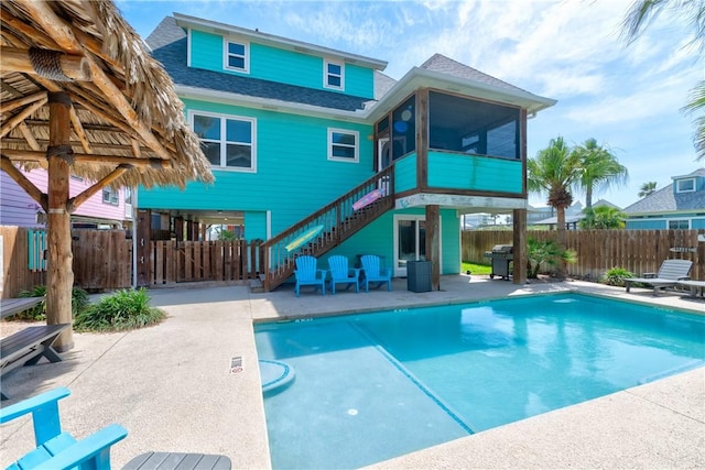 616 Sandcastle Dr, Port Aransas, TX 78373 - view of pool with a sunroom, stairs, a patio, and a fenced backyard