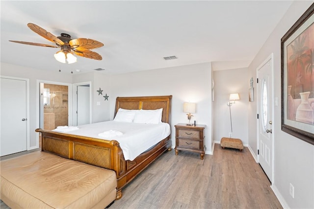 616 Sandcastle Dr, Port Aransas, TX 78373 - bedroom featuring wood finished floors, ceiling fan, ensuite bathroom, and baseboards