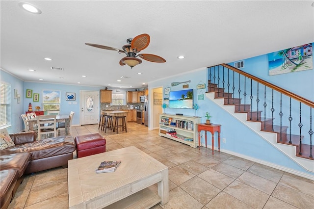 616 Sandcastle Dr, Port Aransas, TX 78373 - living area with a ceiling fan, recessed lighting, stairway, light tile patterned floors, and crown molding