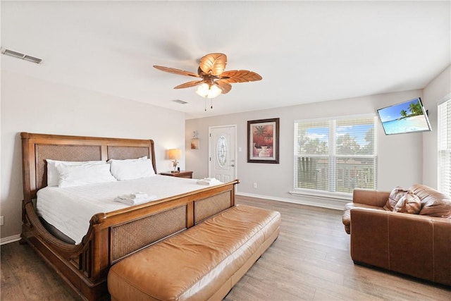 616 Sandcastle Dr, Port Aransas, TX 78373 - bedroom with wood finished floors, baseboards, and ceiling fan
