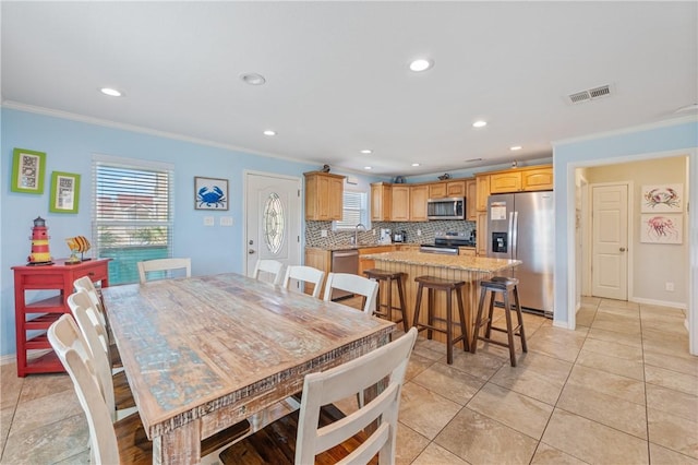 616 Sandcastle Dr, Port Aransas, TX 78373 - dining room with crown molding, recessed lighting, baseboards, and light tile patterned floors