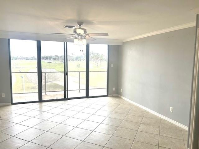 empty room with baseboards, a wall of windows, and crown molding