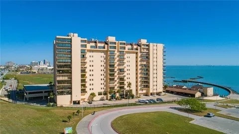 view of building exterior featuring a view of city and a water view