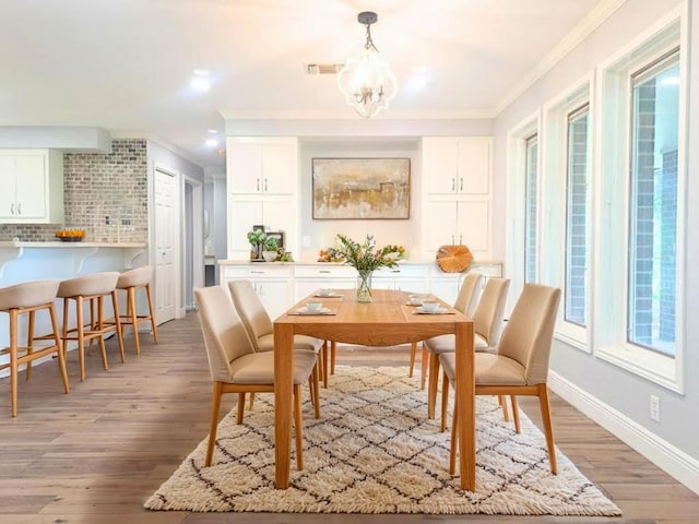 112 Fm 1042, Three Rivers, TX 78071 - dining space featuring crown molding, a chandelier, light wood finished floors, and recessed lighting
