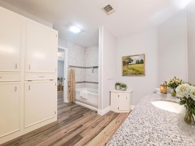 112 Fm 1042, Three Rivers, TX 78071 - bathroom with wood finished floors, vanity, and shower / tub combination