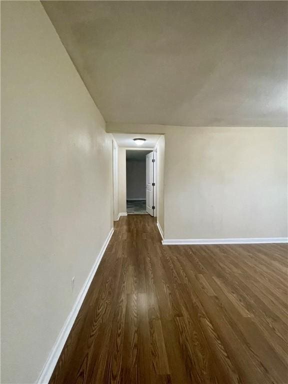 corridor featuring dark wood-type flooring