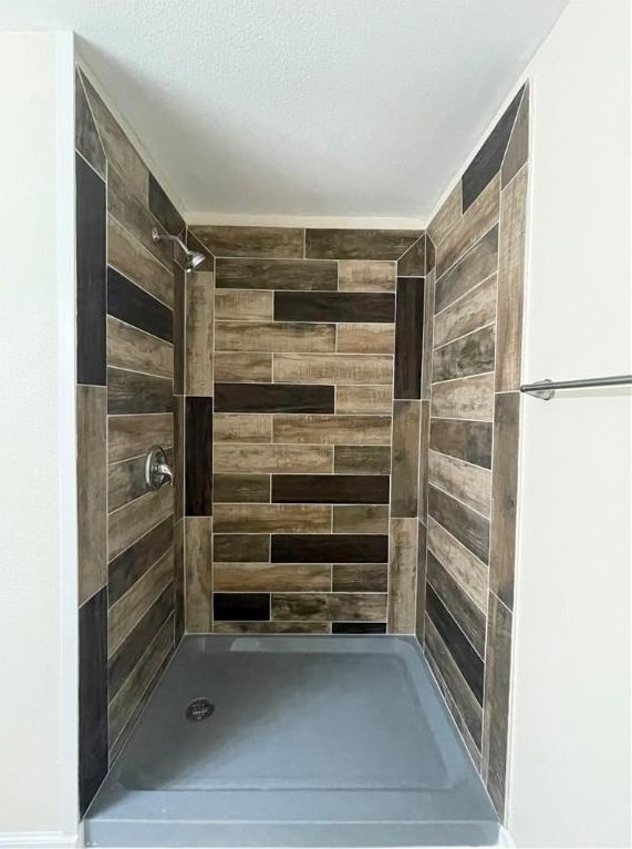 bathroom with tiled shower