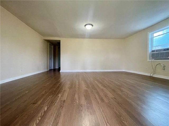 empty room featuring dark hardwood / wood-style flooring and cooling unit