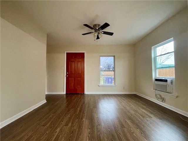 empty room featuring cooling unit, dark hardwood / wood-style floors, and ceiling fan