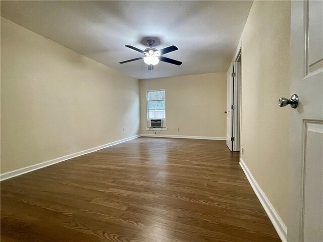 unfurnished bedroom with dark wood-type flooring, cooling unit, and ceiling fan