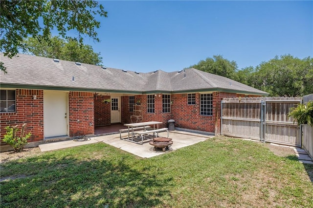537 Vista Dr, Odem, TX 78370 - rear view of property featuring a patio area, a fire pit, and brick siding
