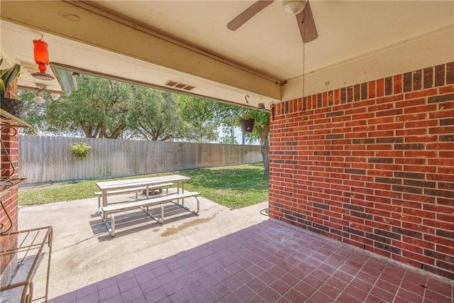 537 Vista Dr, Odem, TX 78370 - fenced backyard featuring ceiling fan, outdoor dining area, and a patio