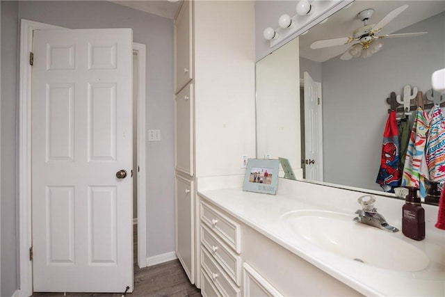 537 Vista Dr, Odem, TX 78370 - bathroom featuring a ceiling fan, vanity, wood finished floors, and baseboards