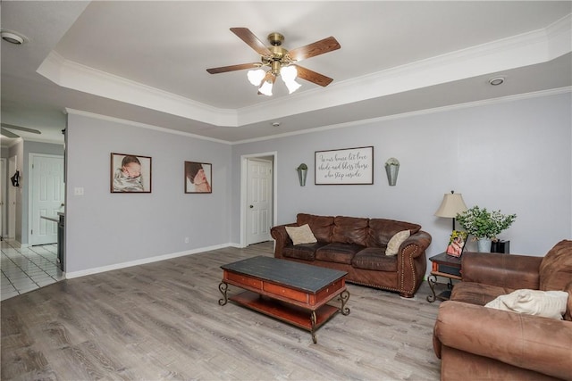 537 Vista Dr, Odem, TX 78370 - living room with a ceiling fan, a raised ceiling, wood finished floors, ornamental molding, and baseboards