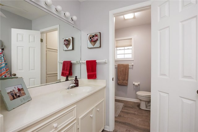 537 Vista Dr, Odem, TX 78370 - bathroom with wood finished floors, vanity, toilet, and baseboards