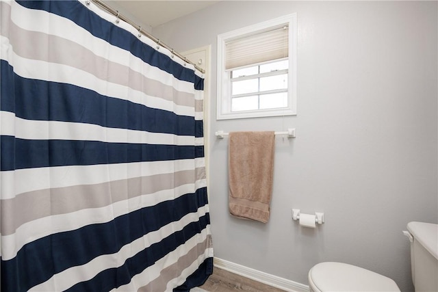537 Vista Dr, Odem, TX 78370 - bathroom featuring toilet, baseboards, wood finished floors, and curtained shower