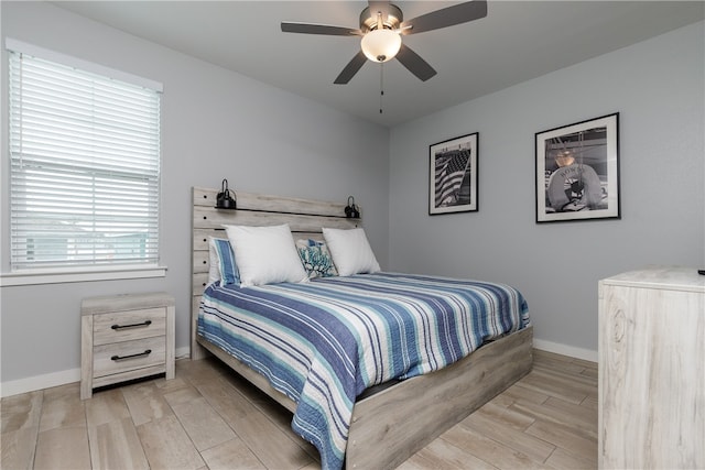 bedroom with ceiling fan and light hardwood / wood-style flooring