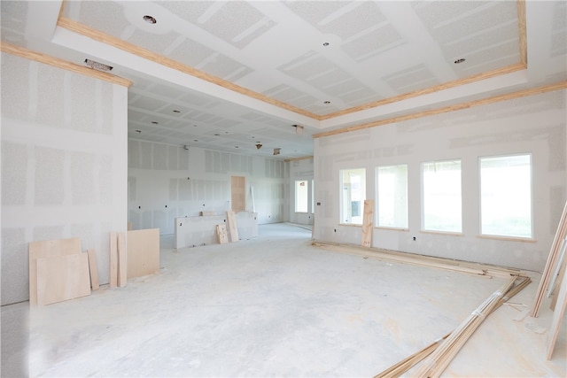 empty room with crown molding and a tray ceiling