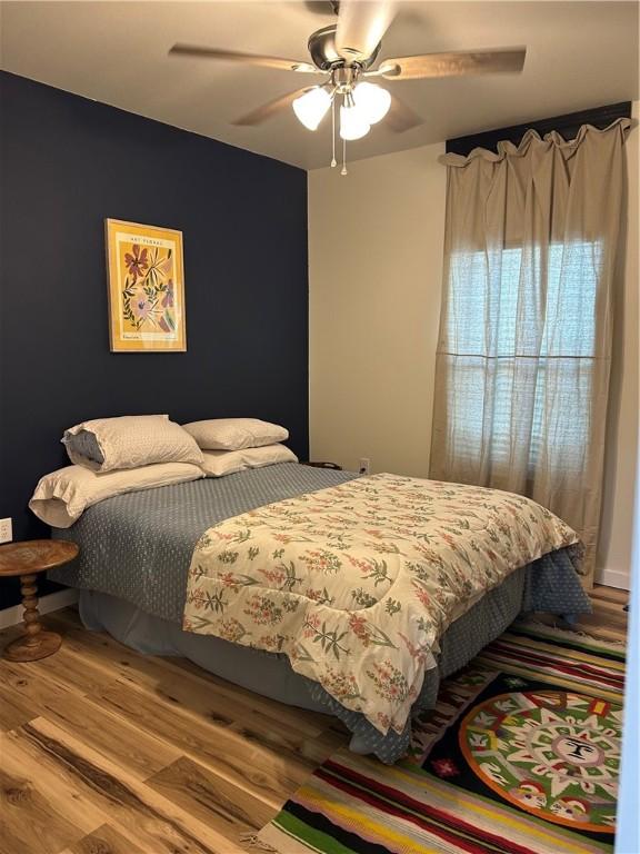 bedroom with wood finished floors and ceiling fan