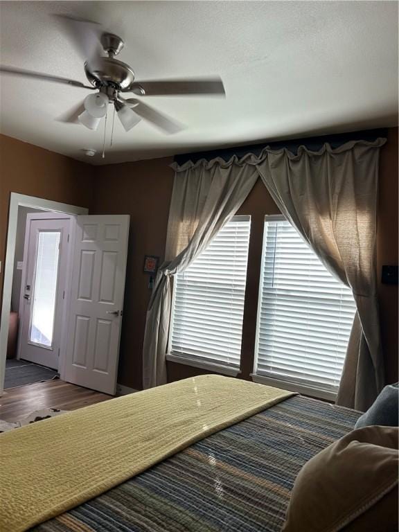 bedroom with wood finished floors and a ceiling fan