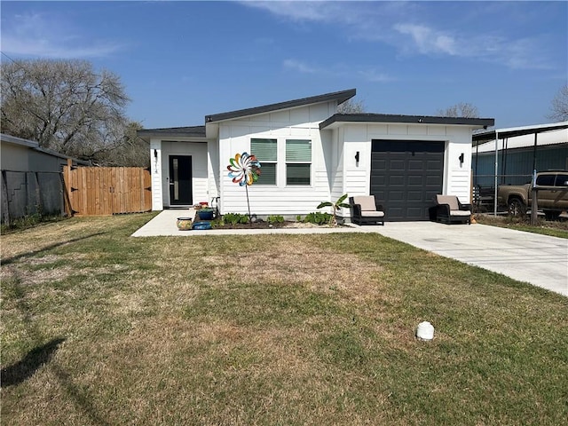 view of front of property with a front lawn, concrete driveway, an attached garage, and fence